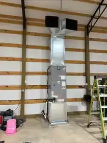 Vertical air handler installation inside a large shop building