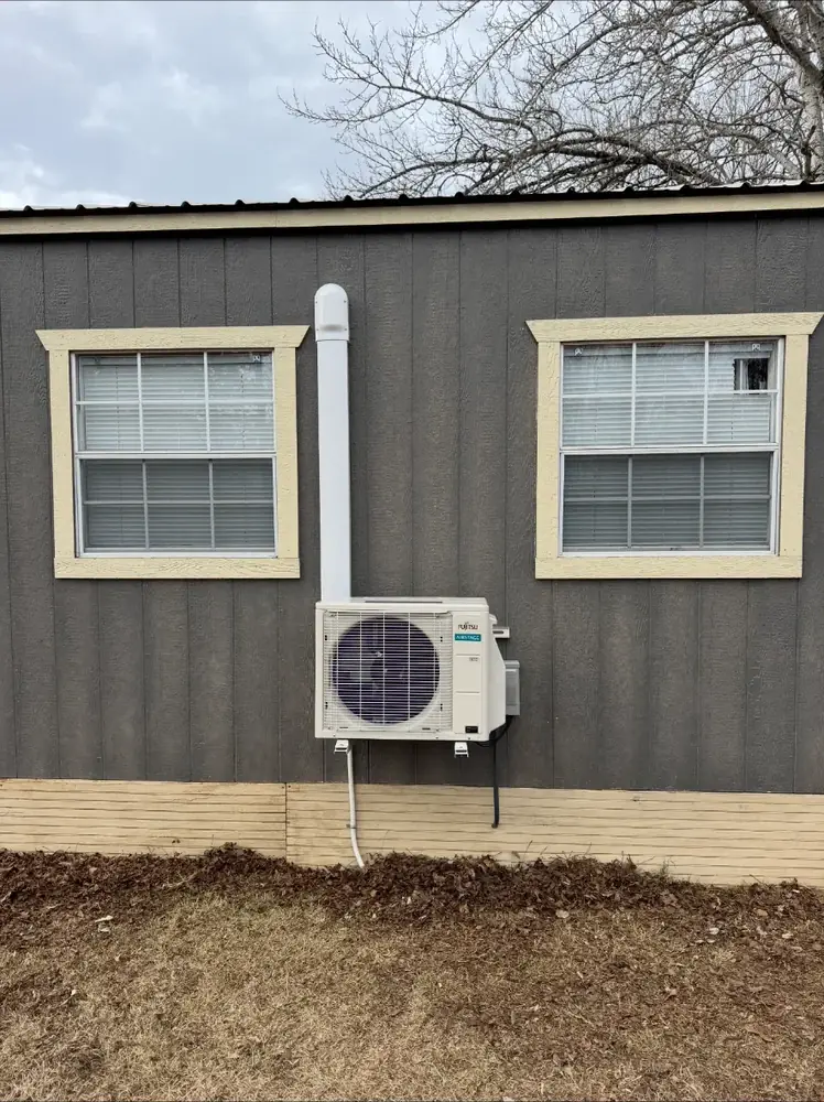 Single outdoor mini split condenser installed on the side of a home