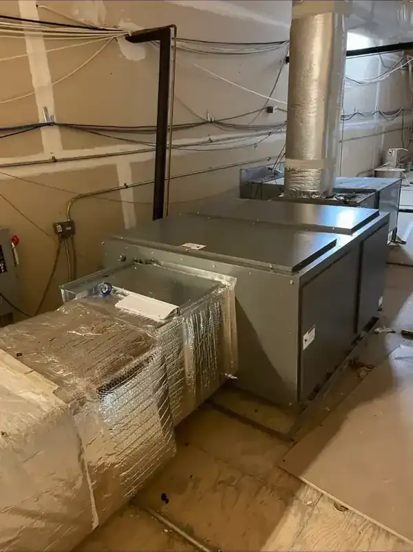 Commercial HVAC unit and ductwork installed in a mechanical room